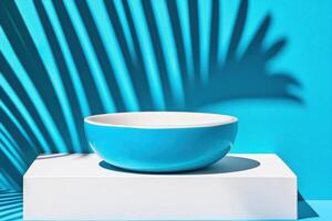 Stylish blue bowl on a pedestal against a tranquil blue background with soft shadows creating a modern artistic vibe photo
