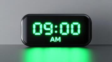 Sleek digital alarm clock displays 09.00 AM in bright neon green light from a low angle, enhancing modern decor with its minimalistic design photo