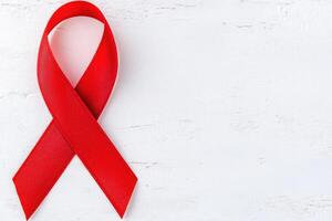 Red ribbon symbolizing awareness and support for health causes such as HIV AIDS and heart disease throughout the year in various communities photo