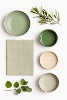 Arrangement of elegant dinnerware and natural elements showcasing a minimalist aesthetic in soft green tones photo