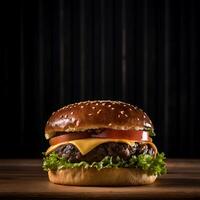 A hamburger with cheese and tomatoes on a wooden table photo
