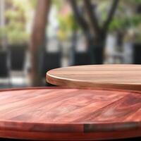 Two Round Wooden Table Tops in a Blurred Outdoor Cafe Setting photo