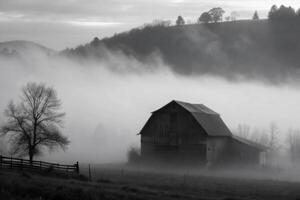 Misty Morning Fog Envelops a Rustic Barn in a Picturesque Valley photo