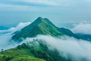 Majestic Mountain Peak Enveloped in Misty Clouds Scenic Landscape photo