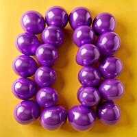A vibrant arrangement of purple balloons forming the number zero on a yellow background photo