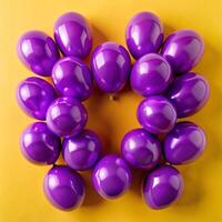 Many Purple Balloons Arranged in a Heart Shape on a Yellow Background photo
