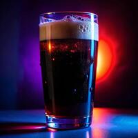 A pint of dark beer illuminated by vibrant purple and red neon lights in a dimly lit bar setting photo