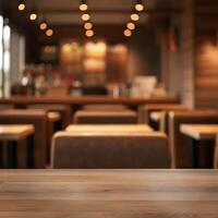 Empty Wooden Table in a Blurred Cozy Cafe Setting with Warm Lighting photo