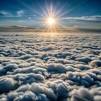 The sun shines over the clouds in this photo
