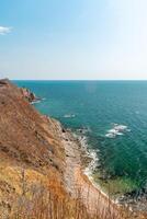View of the vastness of the Pacific Ocean from the high seashore.... High cliffs on the shore of the Pacific Ocean. photo