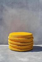 Bright yellow outdoor round pouf with woven rope design, perfect for adding pop of color to any space. Ideal for gardens, patios, or modern decor photo