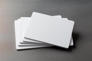 Stacked Collection of Five Blank White Credit Card Mockups for Design and Presentation Purposes on a Neutral Background photo