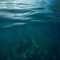 Stunning Teal Ocean Water Surface and Underwater View Showing Gentle Waves and Underwater Seabed photo
