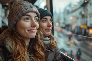 Two women looking out the window of a bus photo