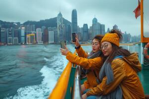 Two women taking a selfie on a boat in hong kong photo