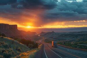 A truck driving down a highway at sunset photo