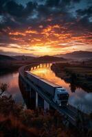 A truck driving on a bridge at sunset photo