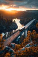 A truck driving on a bridge at sunset photo