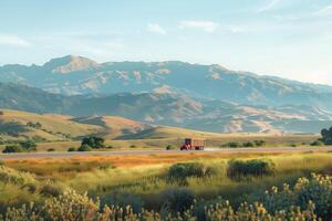 A truck driving down a road with mountains in the background photo
