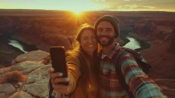 A man and woman taking a selfie at sunset photo