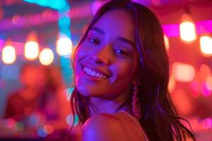 A woman smiling in front of neon lights photo