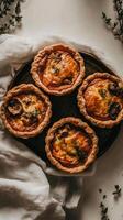 Mini chicken and mushroom quiches gracefully suspended above a soft linen backdrop creating an inviting editorial look photo