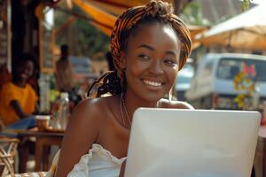 A woman smiles while using a laptop photo