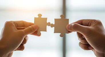 Two hands join puzzle pieces, symbolizing connection and collaboration against a serene background photo