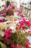 A set festive table in the open air. The table is decorated with candles and flowers photo