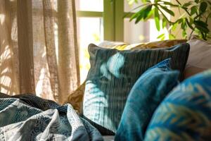 Cozy living space with sunlight streaming through sheer curtains, illuminating a textured blue pillow photo