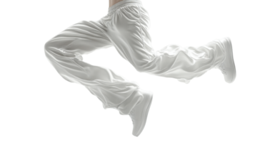 Dynamic jump in white athletic pants and shoes, showcasing movement and energy png