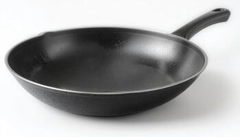 A sleek black frying pan with a smooth, non-stick surface, symbolizing modern cookware, suitable for culinary promotions, cooking shows, or kitchen supplies advertising. photo