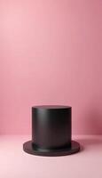 A clean display featuring a black cylindrical platform on a textured pink background, ideal for product displays, branding, or creative showcases in various contexts. photo