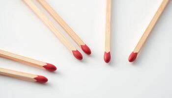 Several matches with red tips arranged visually, showcasing simplicity and creativity, perfect for concepts related to fire, safety, or lighting. photo