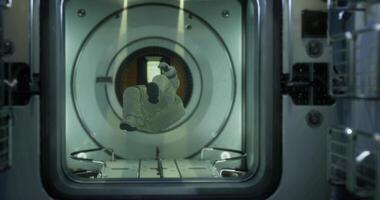 Astronaut floating in spacecraft module during space exploration mission video