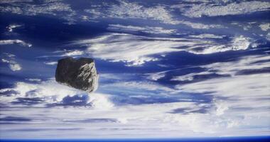 Large asteroid floating in the atmosphere above Earth during the day video