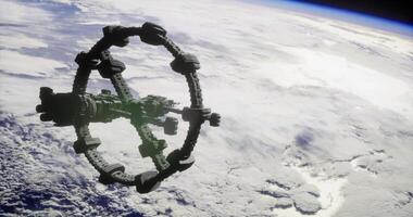 View of a futuristic space station orbiting Earth amidst clouds video