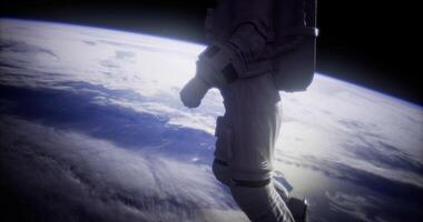 Astronaut floating in space above Earth during a spacewalk exploration video