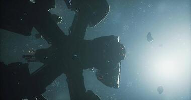 Spaceship silhouette against distant stars and asteroids in dark space video