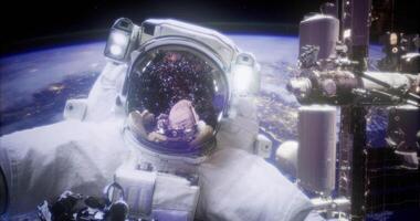 Astronaut in space with Earth and the International Space Station visible video