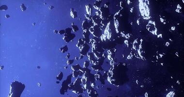 Asteroids cluster in deep space showcasing rocky debris in vast expanse video