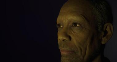 Portrait of an elderly man in soft lighting with a contemplative expression video