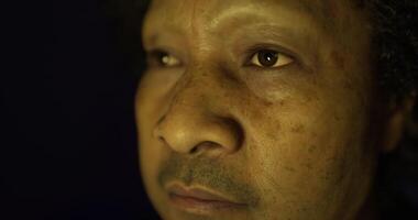 Close up of a man reflecting deeply in low light during a quiet moment video