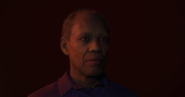 Portrait of an older man with a thoughtful expression against a dark background video