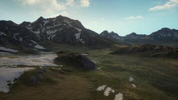 An aerial view of a mountain range with snow on it video