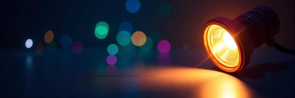 Illuminated Lightbulb with Colorful Bokeh Background photo