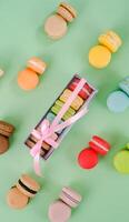 Colorful Macaron Isolated on Green background photo