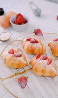 Close Up Photography of Mini Croissant Topped With Strawberry and Icing Sugar photo