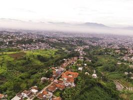 Bandung, Landscape settlement along the plateau. Cityscape of Bandung from a height of 200 meters. Aerial shot from drone. Wallpaper Backgrounds. Negative Space photo