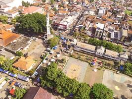 Town square and the Cicalengka Grand Mosque. Panoramic cityscape landscape from a high angle view of mosque with tower and sports court on Town square. photo